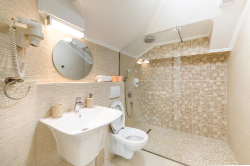 a bathroom with a sink and a toilet at Vila Kos in Mamaia Nord