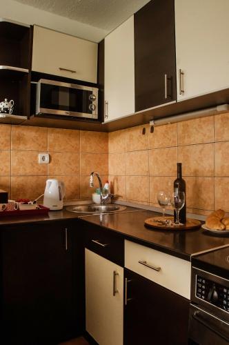 a kitchen with a sink and a microwave at Point in Sarajevo