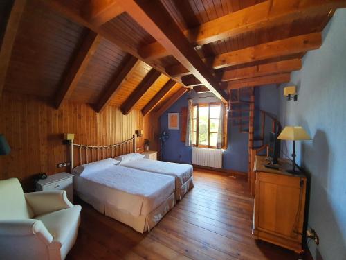 a bedroom with a large bed and a couch at Tierras de Moya in Los Huertos