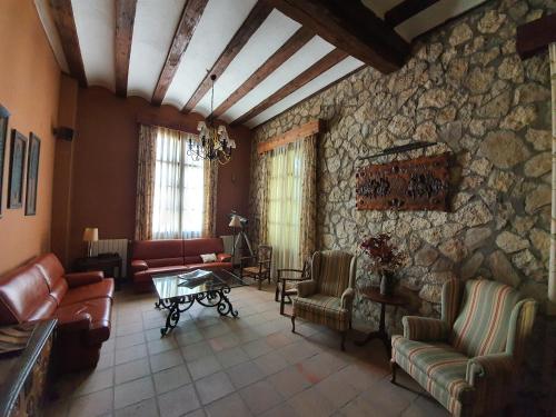 
a living room filled with furniture and a fireplace at Tierras de Moya in Los Huertos
