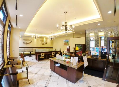 a lobby of a restaurant with tables and chairs at Sol Vita Hotel Naha in Naha
