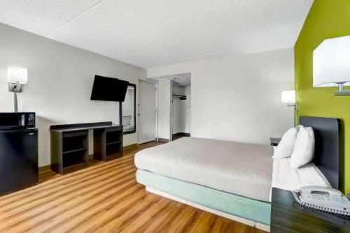 a hotel room with a bed and a flat screen tv at Motel 6-Lawrenceville, NJ in Lawrenceville