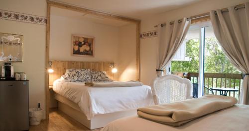 Кровать или кровати в номере Les Suites de L'Anse