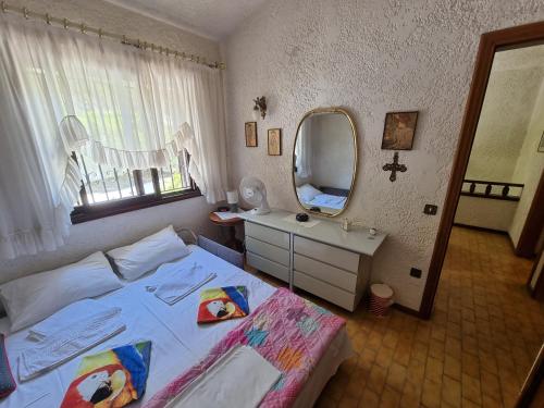 a bedroom with a bed and a sink and a mirror at Beachfront Villa 100m from Sea for up to 10 guests in Siviri