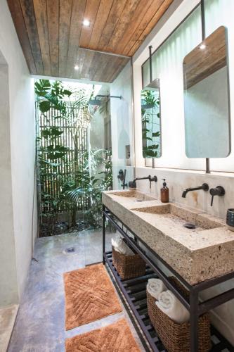 a bathroom with a sink and a large mirror at Surfing Temple Boutique Hotel in General Luna