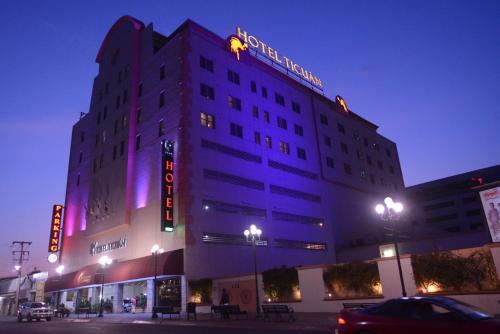 a hotel building with a sign on it at night at Hotel Ticuán in Tijuana