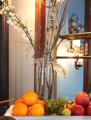 a vase filled with fruit on top of a table at Hotel Montana Zürich in Zürich