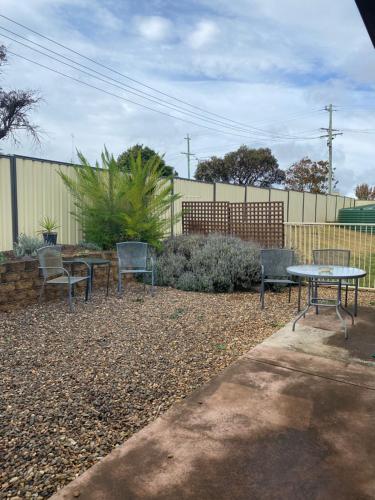 a group of chairs and a table in a yard at Sunray Motor Inn in Toowoomba