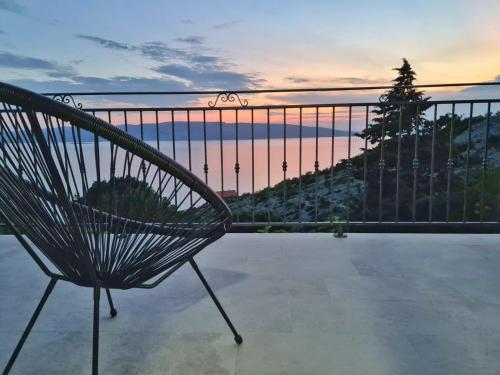 a bench on a balcony with a view of the ocean at Casa sole infinito in Senj