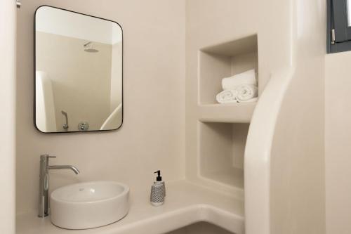 a bathroom with a sink and a mirror at Archon Seaside Retreat in Plaka