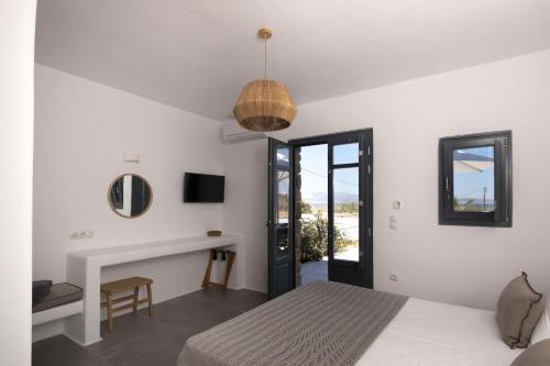 a white bedroom with a bed and a fireplace at Archon Seaside Retreat in Plaka