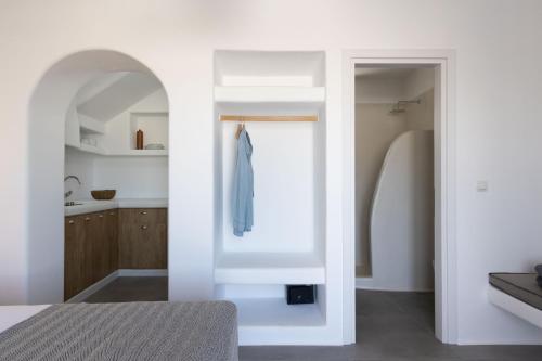 a bedroom with white walls and a window and a bed at Archon Seaside Retreat in Plaka