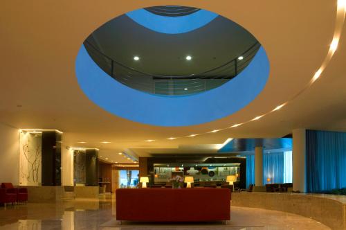 a lobby with a large blue circle on the ceiling at Hotel Santa Maria in Fátima