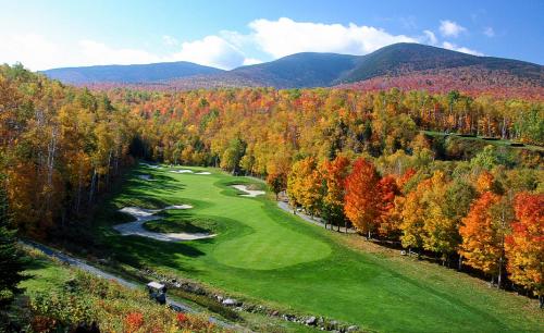 an aerial view of a golf course in the mountains at Sugarloaf Mountain Hotel in Carrabassett