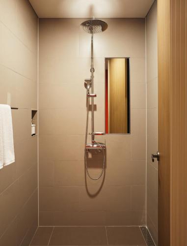 a bathroom with a shower with a glass door at Yeosu Belle Mer in Yeosu