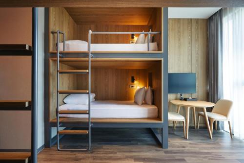 a bunk bed in a room with a desk at Yeosu Belle Mer in Yeosu