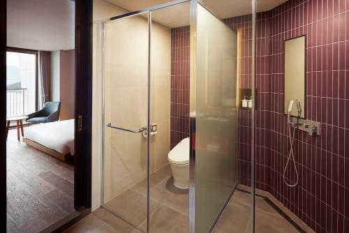a bathroom with a glass shower with a toilet at Yeosu Belle Mer in Yeosu