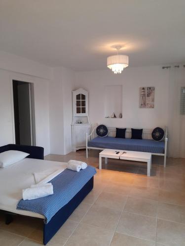 a living room with two beds and a couch at Magda house in Livadi
