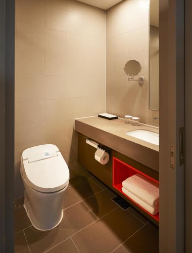 a bathroom with a toilet and a sink at Yeosu Belle Mer in Yeosu