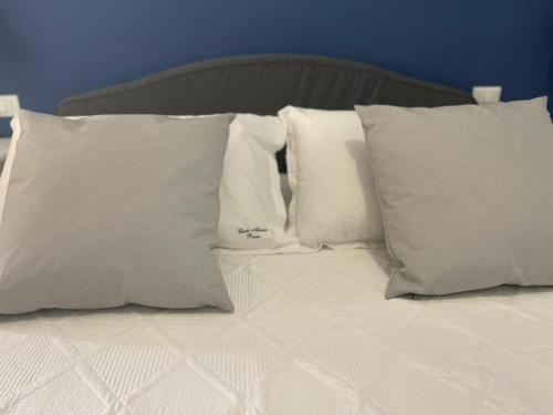 a bed with white pillows on top of it at Carlo Alberto Room in Fasano