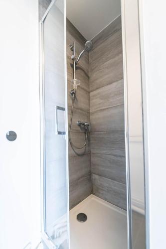 a shower with a glass door in a bathroom at Résidence Le Crystal Dinard Plage in Dinard