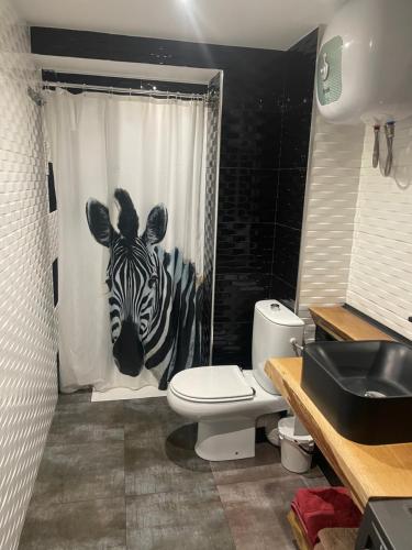 a bathroom with a zebra head on the shower curtain at Estudio Loft in La Pineda