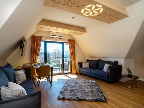 a living room with a blue couch and a table at Aparthotel Góralski Spa 2 in Białka Tatrzanska