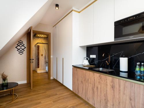 a kitchen with a sink and a counter top at Aparthotel Góralski Spa 2 in Białka Tatrzanska