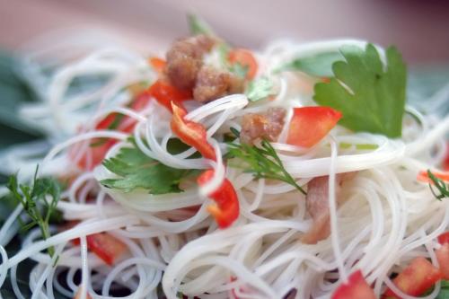 a plate of noodles with meatballs and vegetables at Kaliwa Lodge in Moshi