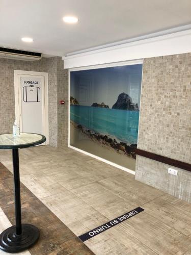 a room with a large painting on the wall at Hostal Rosalia in San Antonio