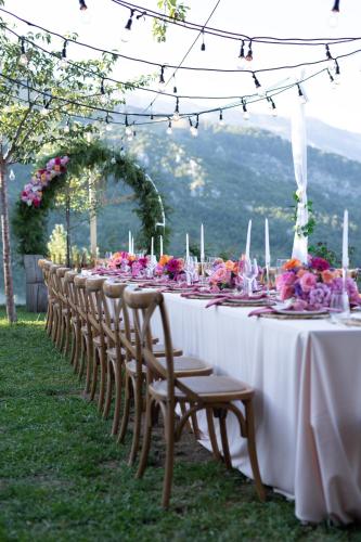 a long table with chairs and flowers on it at Chestnut Hill in Kolgecaj