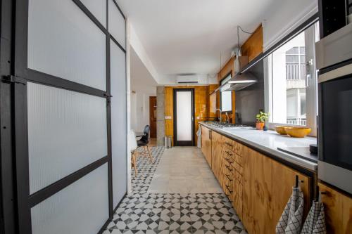 a kitchen with a door and a counter with a sink at Casa Creu Mar in Sant Feliu de Guíxols