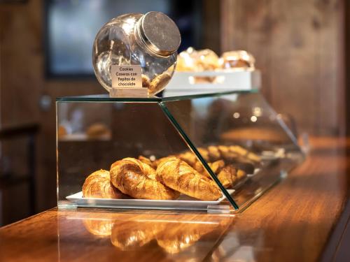 a display case with croissants on a table at Sancho Ramirez in Pamplona