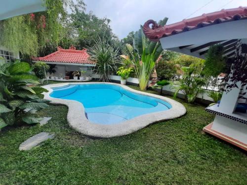 a swimming pool in the yard of a house at SUNKISS VILLA by Yogya Tropicana in Yogyakarta