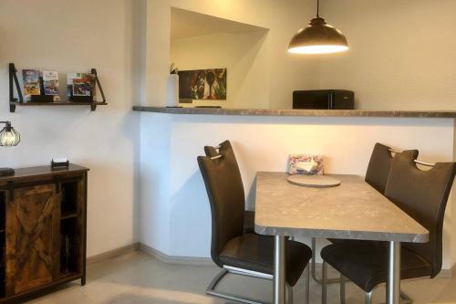 a dining room with a table and some chairs at Ferienwohnung Birkenlodge in Schmallenberg