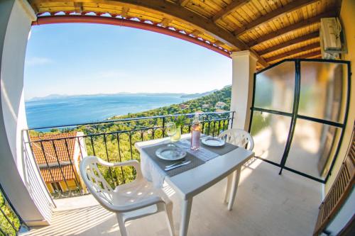 a table and chairs on a balcony with a view at Amalia Complex in Nisakion