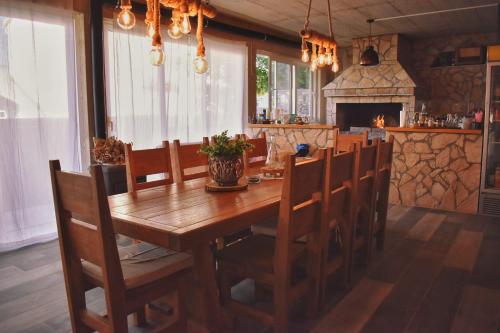 a dining room with a wooden table and chairs at Oguic apartman in Pag