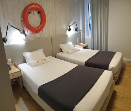 Porto Velho Boutique Hostel tesisinde bir odada yatak veya yataklar