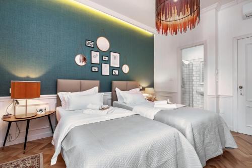 a room with three beds with white sheets at Evala luxury rooms with pool and garden in Split