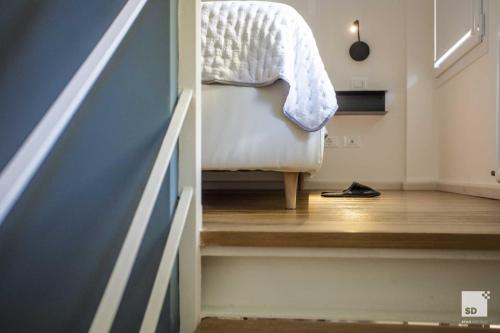 a bedroom with a stairway with a bed and a shoe at Pam Style Home in Bologna