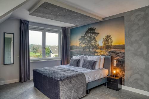 a bedroom with a bed with a painting on the wall at B & B De Elsterberg in Elst