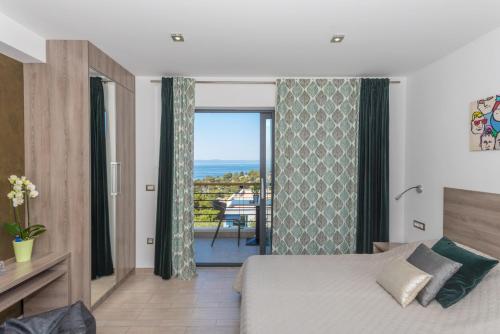 a bedroom with a bed and a balcony at Villa Steffi in Baška Voda