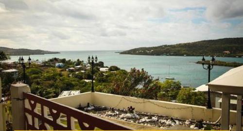 a view of the ocean from a balcony of a house at Casa Robinson Guest House in Culebra