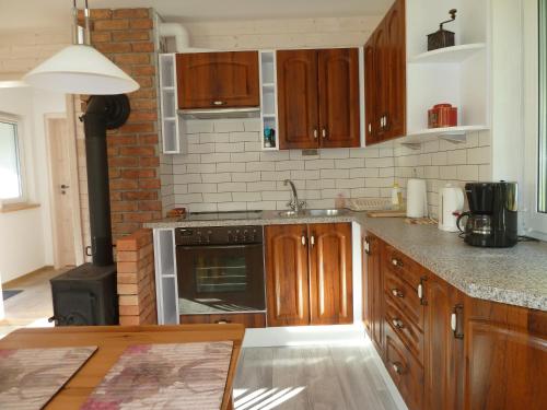 a kitchen with wooden cabinets and a stove top oven at Orle in Orle