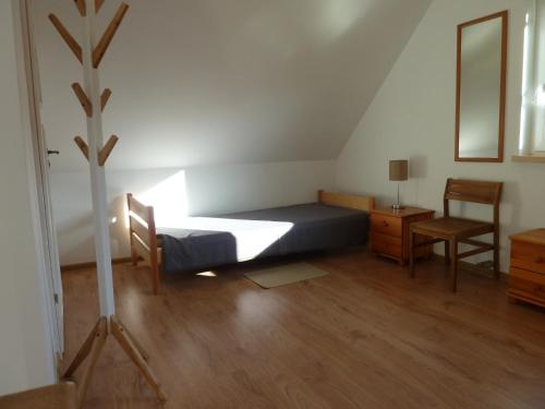 a bedroom with a bed and a desk and a chair at Orle in Orle