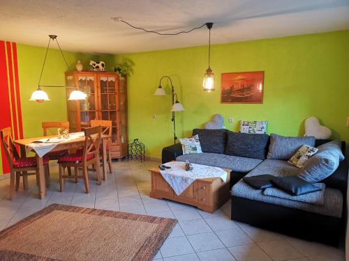 sala de estar con sofá y mesa en Ferienwohnung im Landhausstil en Oberreute