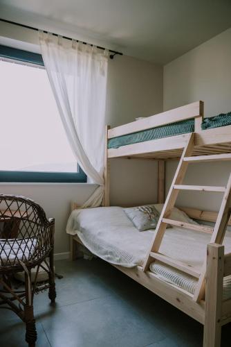 a bedroom with two bunk beds and a window at Apartament Sielanka in Międzybrodzie Bialskie
