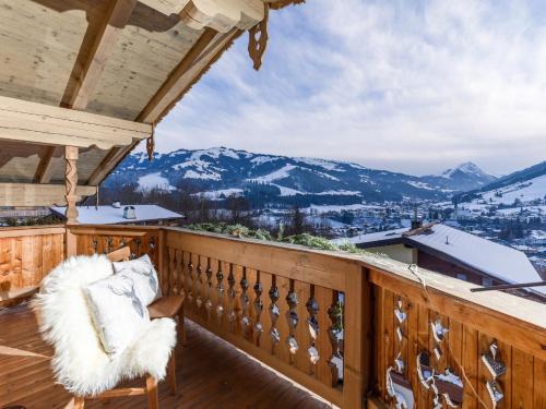 a balcony with a view of snow covered mountains at Chalet Weinberg Top 1 & Top 2 by Apartment Managers in Kirchberg in Tirol