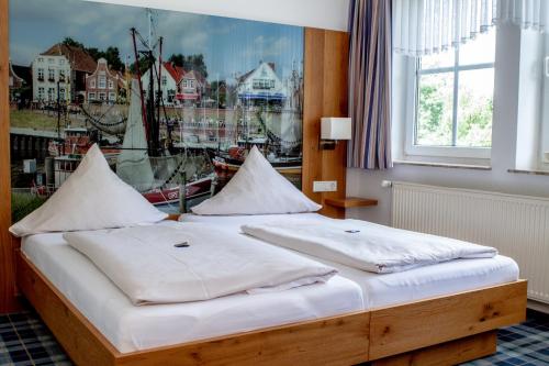 מיטה או מיטות בחדר ב-Landhaus Oltmanns