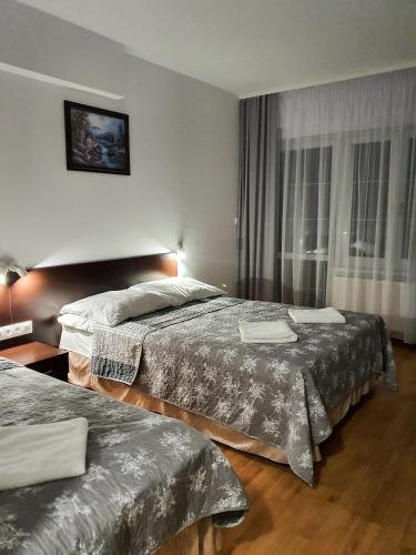 Postel nebo postele na pokoji v ubytování Astoria